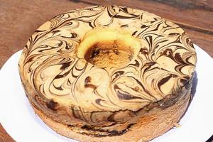 Homemade round sponge cake mix on white table. photo