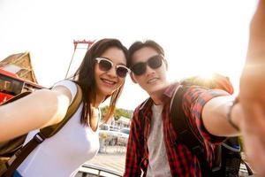 Asian couple tourists taking selfie while traveling in Bangkok Thailand photo