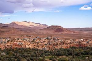 Scenic landscape of buildings in town with mountains backdrop photo