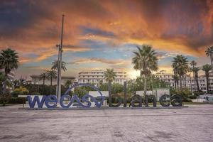 Large letters we casablanca inscription at square against dramatic sky photo