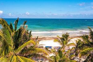 Aerial Tulum coastline by the beach with a magical Caribbean sea and small huts by the coast. photo