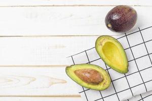 Avocado on white wooden table photo