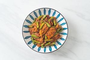 Stir fried pork with red curry paste photo