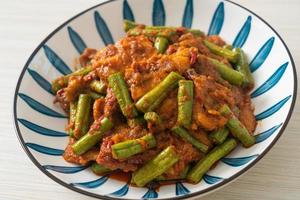 Stir fried pork with red curry paste photo