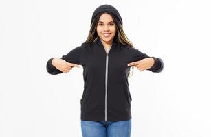Afro american woman in black hoodie pointing with both hands at it, girl in sweatshirt mock up photo