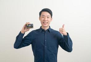 young Asian man holding credit card photo