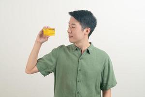 young Asian man holding credit card photo