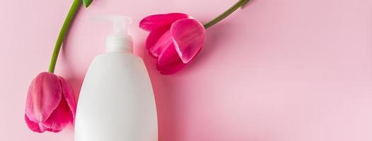 Cosmetics for spa treatments on a pink background. photo