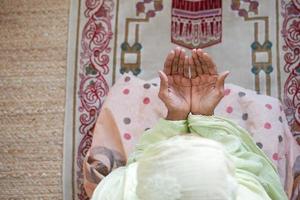 Close up of senior women hand praying at ramadan , top view photo