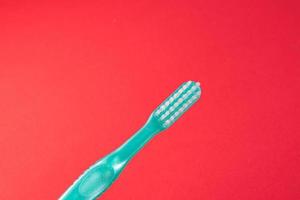 cepillo de dientes verde sobre fondo rojo