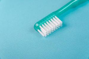 cepillo de dientes verde sobre fondo azul foto
