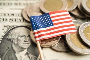 Stack of coins with USA America flag on dollar banknotes. photo