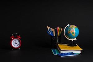 colorful collection of school supplies set on black background. back to school. great ideas photo