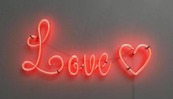 red neon lamp with the word LOVE and a heart photo