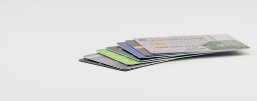 Stack of multi colored credit cards on a white background. Isolated photo