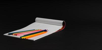 album for drawing and color pencils on a black background, isolated. back to school photo