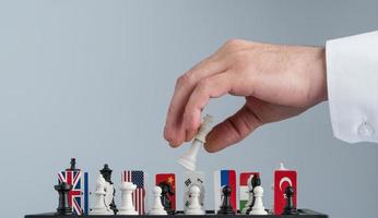Politician's hand moves a chess piece. Conceptual photo of a political game and strategy.