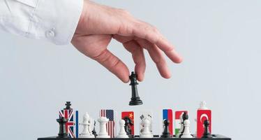 Politician's hand moves a chess piece. Conceptual photo of a political game and strategy.