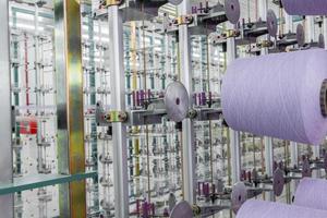 purple textile yarn on the warping machine. machinery and equipment in a textile factory photo