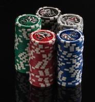 Casino chips on a black background with reflection. The concept of gambling and entertainment. Casino and poker photo