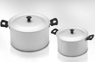 several cooking pots on a light background photo