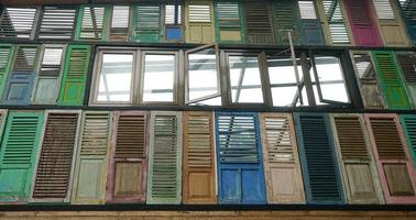 The design of old windows in various colors decorates a house photo