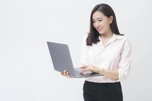 An asian woman is holding laptop computer on white Studio background photo