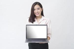 An asian woman is holding laptop computer on white Studio background photo