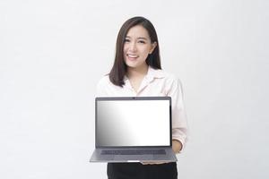 An asian woman is holding laptop computer on white Studio background photo