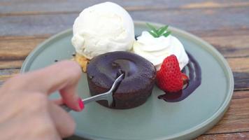 chocolate lava with vanilla ice-cream and whipping cream on plate video