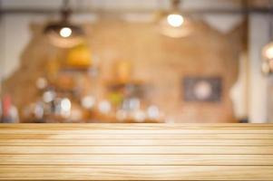 Brown Wooden table on coffee shop or restaurant background . photo