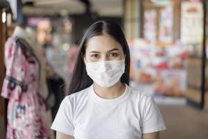 young woman with mask standing outdoor photo