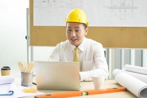 A male engineer using laptop, making video call to client or business partner, photo