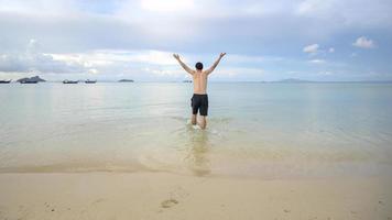happy man enjoying and relaxing on the beach, Summer and holidays concept photo