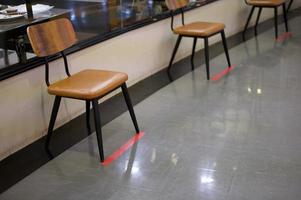 Social distancing chairs in front of restaurant , Coronavirus protection concept . photo