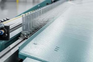 macro shot of a stretched thread. machinery and equipment in a textile factory photo