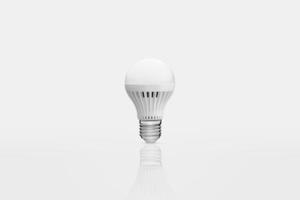 one energy saving lamp on a white background with reflection photo