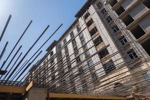reinforcement bars for concrete pouring on the background of the building under construction. close-up, bottom view photo