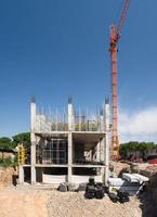 construction crane and a concrete structure of the building on a background the sky photo