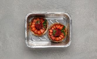 fast food in a foil box on a gray background. a healthy food close up photo