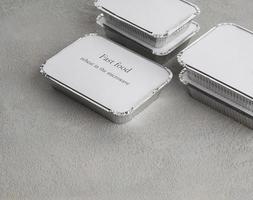 set of fast food in a box of foil on a gray rough background. food for businessman and busy people photo