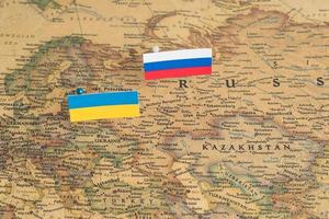 Flags of the Russia and Ukraine on the world map. Conceptual photo, politics and world order, political differences photo