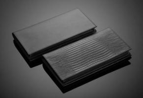 Fashionable leather men's wallet on a dark background photo