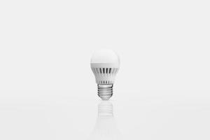 one energy saving lamp on a white background with reflection photo