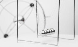 balancing balls on a white background. business concept. Newtons Cradle photo