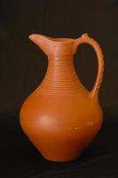 oriental antique jug ceramic on a black background closeup photo