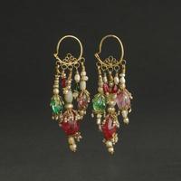 ancient antique earrings with stones on black background. Middle Asian vintage jewelry photo