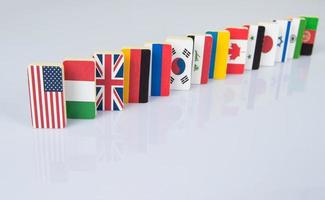 Domino effect with tiles of flags of different countries of the world. conceptual photo, political games photo