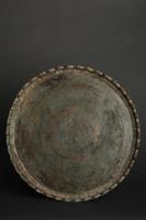 ancient oriental metal tray on dark background. antique bronze tableware photo