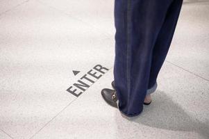 Close up woman legs is standing on social distancing line in shopping mall , New normal , social distancing, covid-19 prevention concept photo